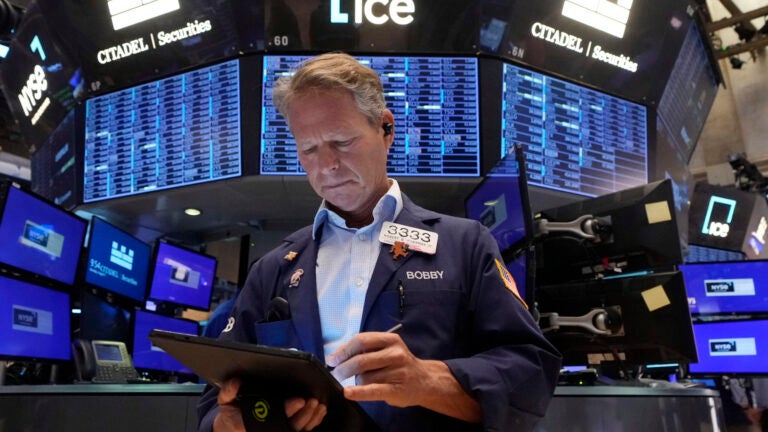 Trader Robert Charmak works on the floor of the New York Stock Exchange, Monday, Aug. 5, 2024.